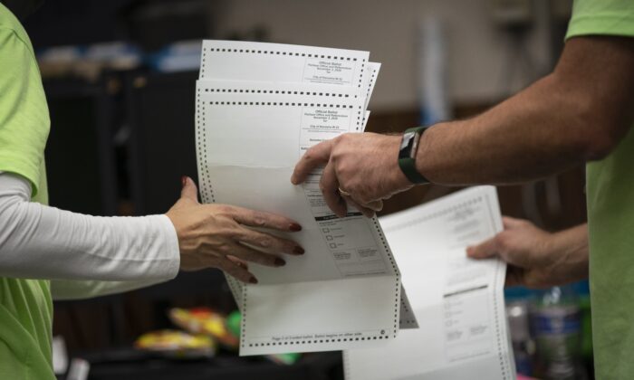 Poll workers sort out early and absentee ballots at the Kenosha Municipal building on Election Day in Kenosha, Wis., on Nov. 3, 2020. (Wong Maye-E/AP Photo)