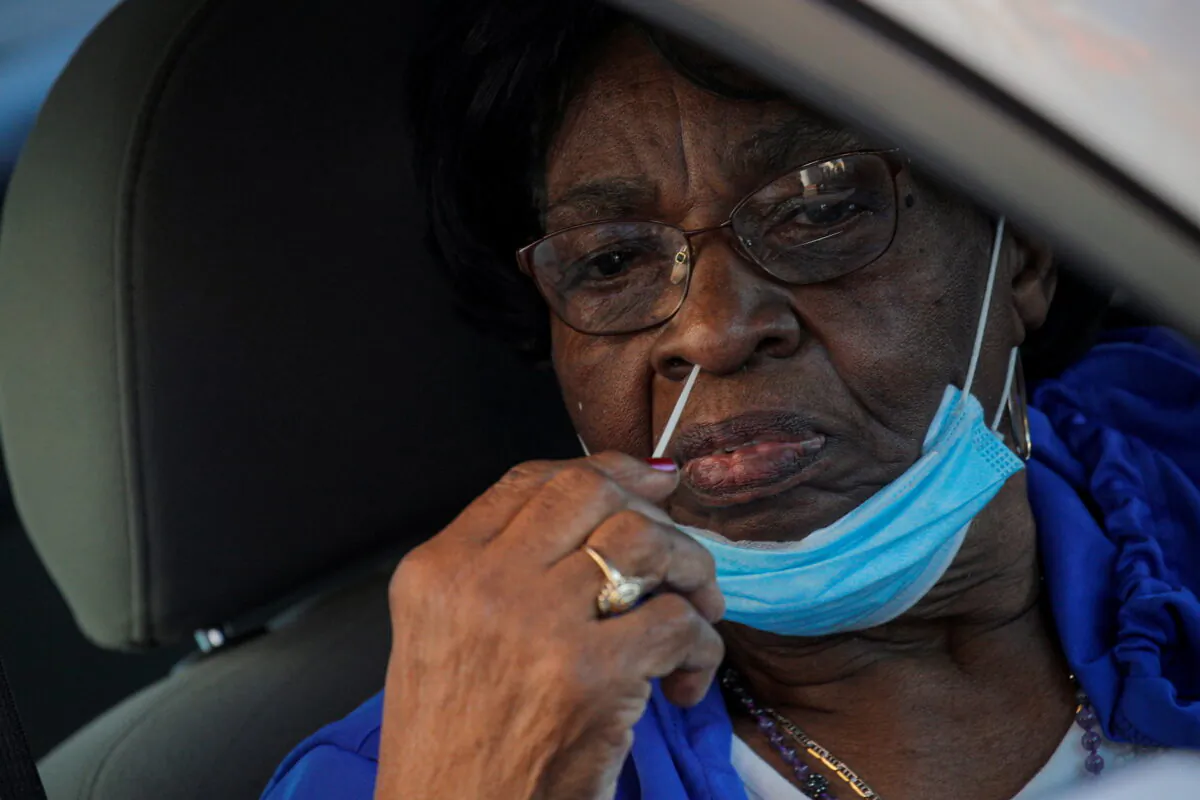 A woman takes a test for the coronavirus disease (COVID-19) in Staten Island, New York, U.S., Nov. 10, 2020.  (Reuters/Brendan McDermid)
