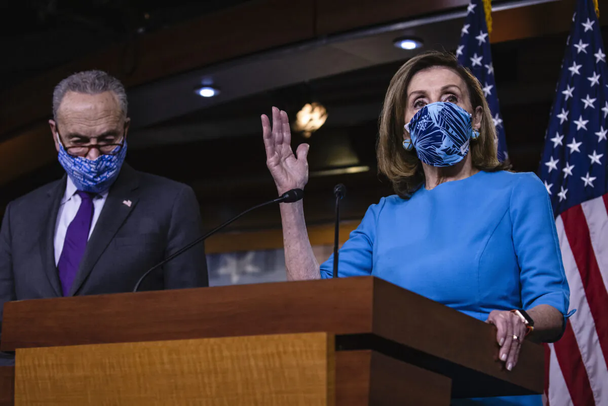 Speaker of the House Nancy Pelosi (D-Calif.) speaks alongside Senate Minority Leader Chuck Schumer (D-N.Y.) during a joint press conference at the U.S. Capitol in Washington, on Nov. 12, 2020. (Samuel Corum/Getty Images)