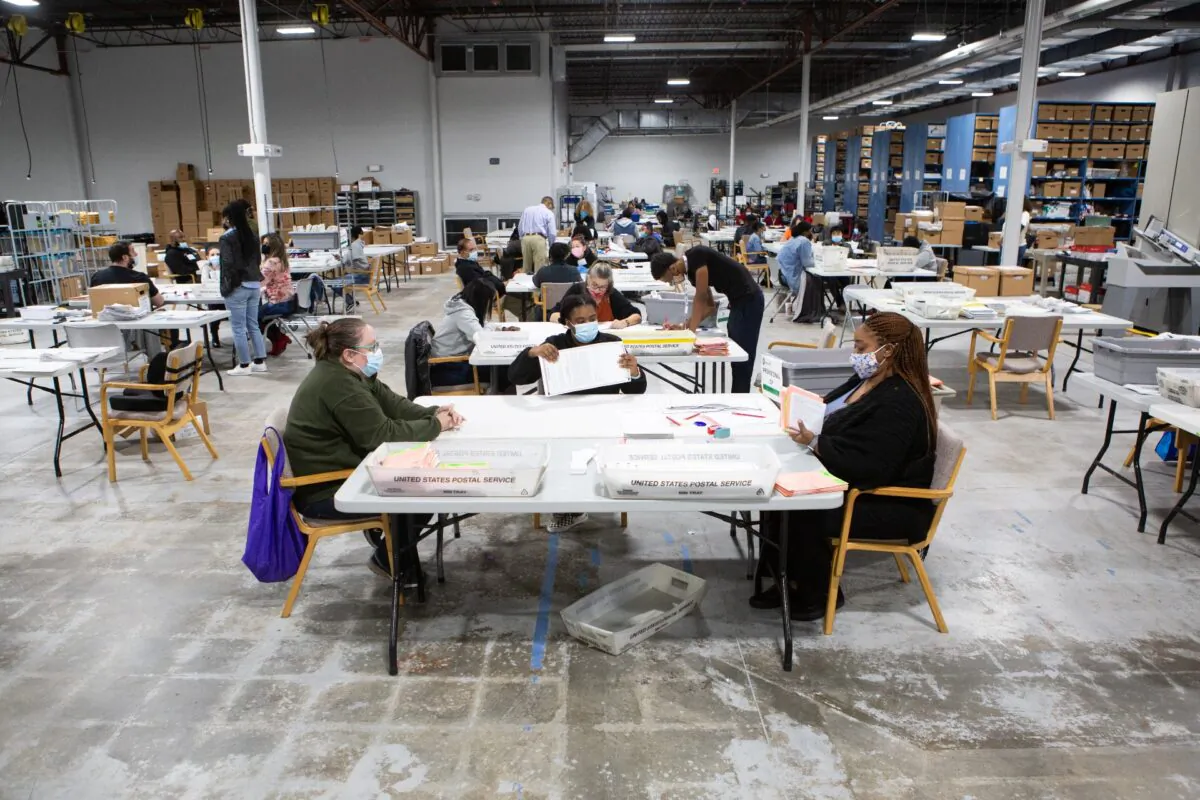 Gwinnett County election workers look over absentee and provisional ballots at the Gwinnett Voter Registrations and Elections office in Lawrenceville, Ga., on Nov. 6, 2020. (Jessica McGowan/Getty Images)