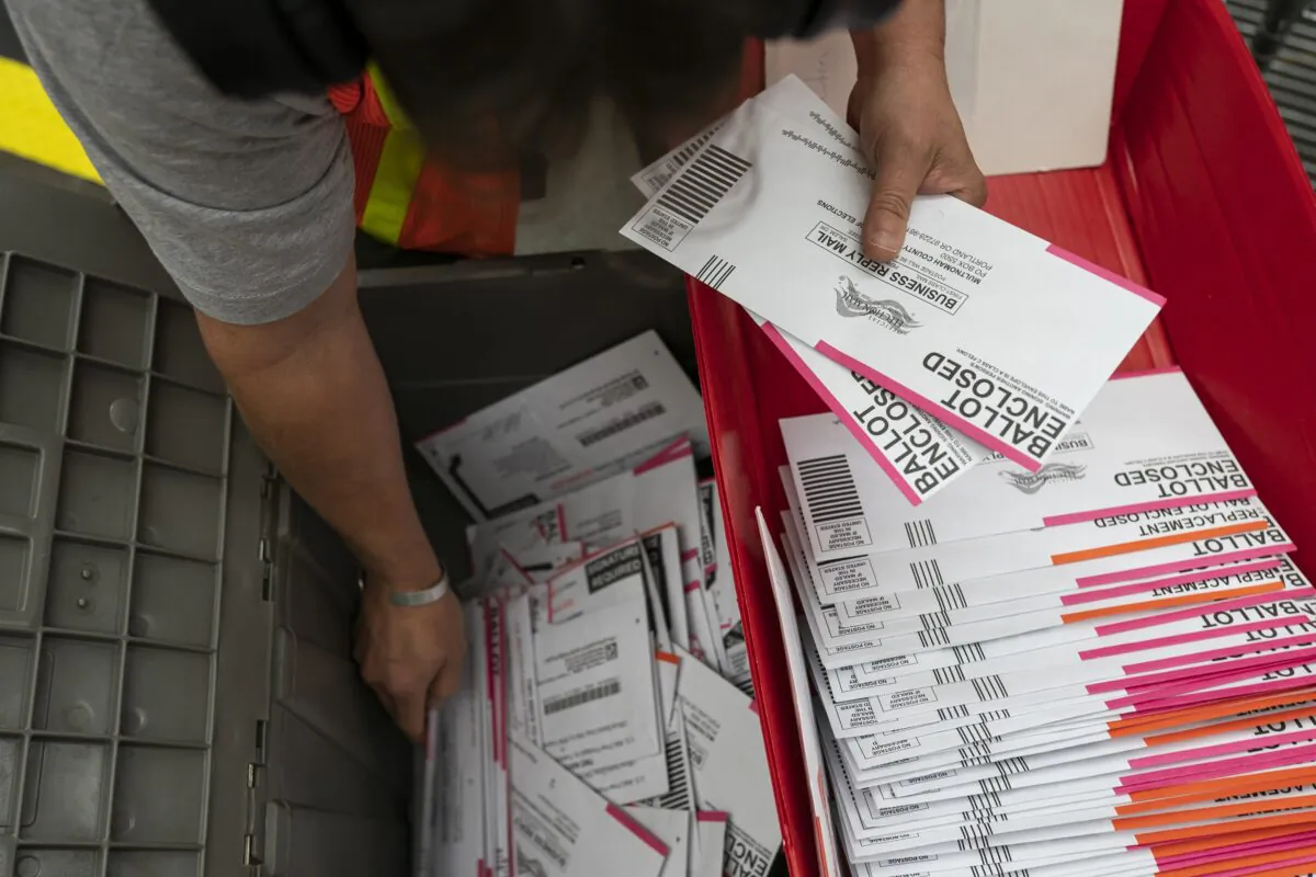 An election worker sorts submitted ballots at the Multnomah County Elections Office in Portland, Ore., on Nov. 2, 2020. (Nathan Howard/Getty Images)