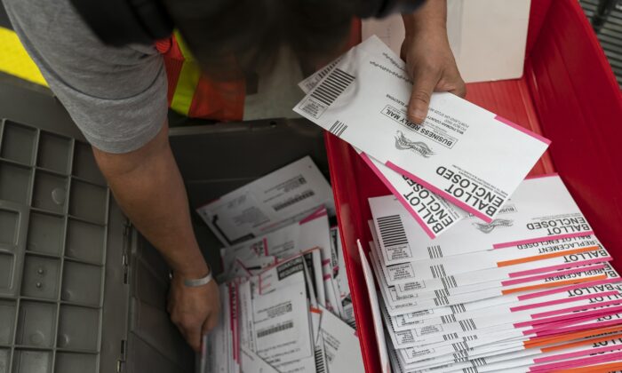 An election worker sorts submitted ballots at the Multnomah County Elections Office in Portland, Ore., on Nov. 2, 2020. (Nathan Howard/Getty Images)
