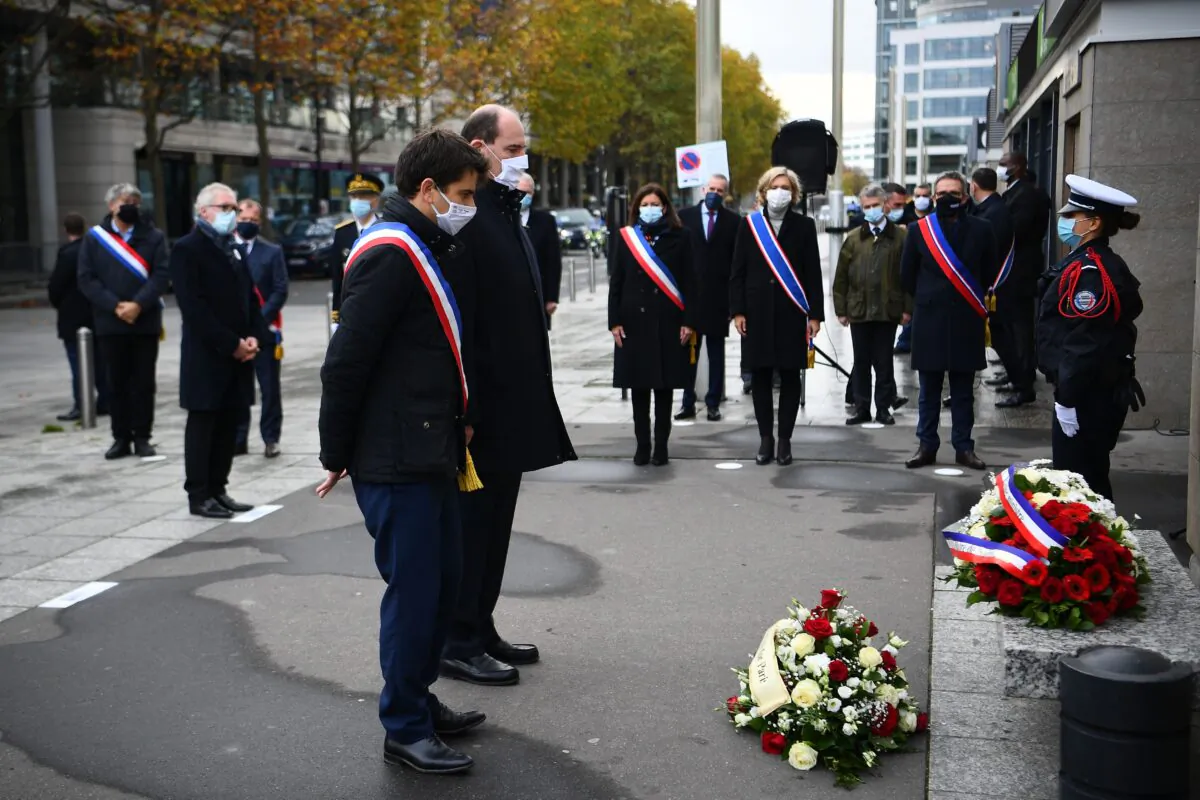 Saint-Denis Mayor Mathieu Hanotin (L), French Prime Minister Jean Castex (C) and Paris Mayor Anne Hidalgo (3rdR) pay tribute to victim of the 2015 Paris attacks outside the Stade de France stadium in Saint-Denis on Nov. 13, 2020. (Christophe Archambault/Pool/AFP via Getty Images)