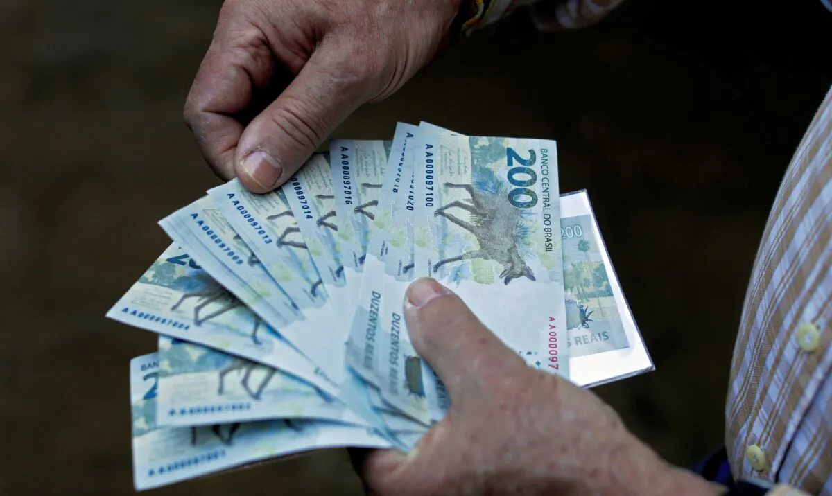 A man holds 200-real notes after Brazil's Central Bank issued them in Brasilia on Sept. 2, 2020. (Sergio Lima/AFP via Getty Images)