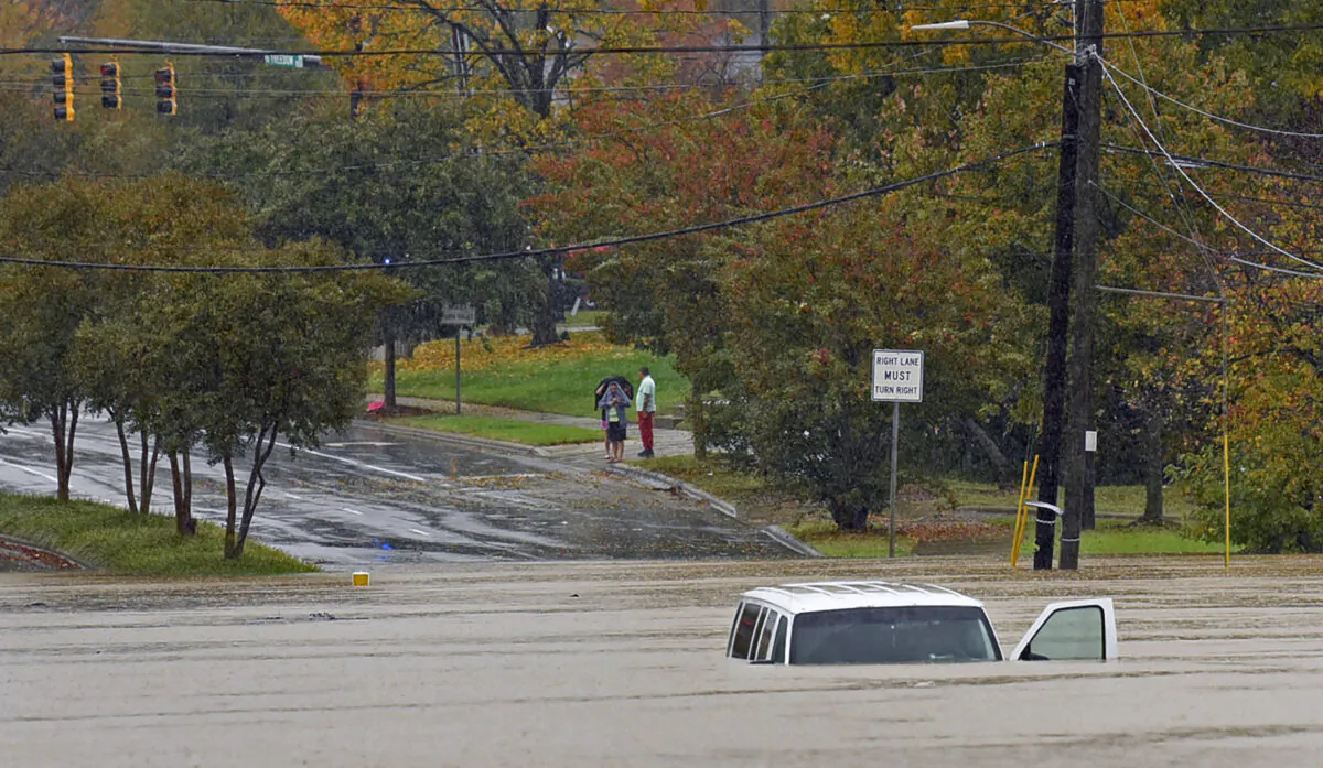 A vehicle is submerged in floodwater on Freedom Drive in Charlotte, N.C., on Nov. 12, 2020. (Jeff Siner/The Charlotte Observer via AP)