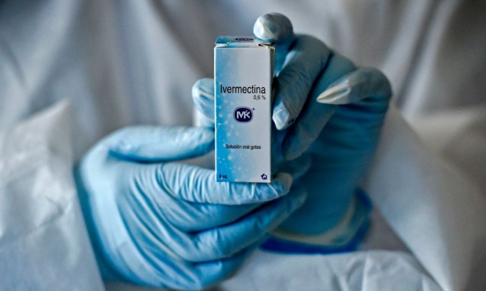 A health worker shows a box containing a bottle of Ivermectin, a medicine authorized by the National Institute for Food and Drug Surveillance (INVIMA) to treat patients with mild, asymptomatic or suspicious COVID-19, as part of a study of the Center for Pediatric Infectious Diseases Studies, in Cali, Colombia, on July 21, 2020. (Luis Robayo/AFP via Getty Images)