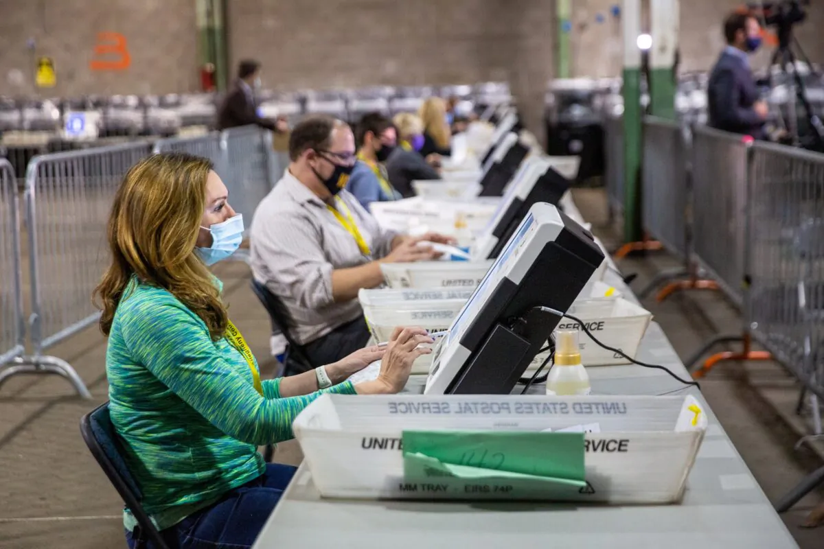 Poll workers tabulate ballots at the Allegheny County Election Warehouse after the election in Pittsburgh, Pa., on Nov. 6, 2020. (John Altdorfer/Reuters)