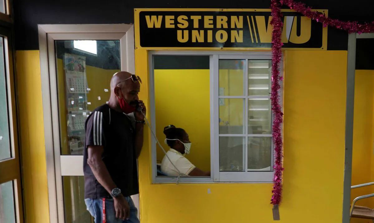 A man talks on the phone outside a Western Union office, in Havana, Cuba, on Oct. 28, 2020. (Alexandre Meneghini/Reuters)