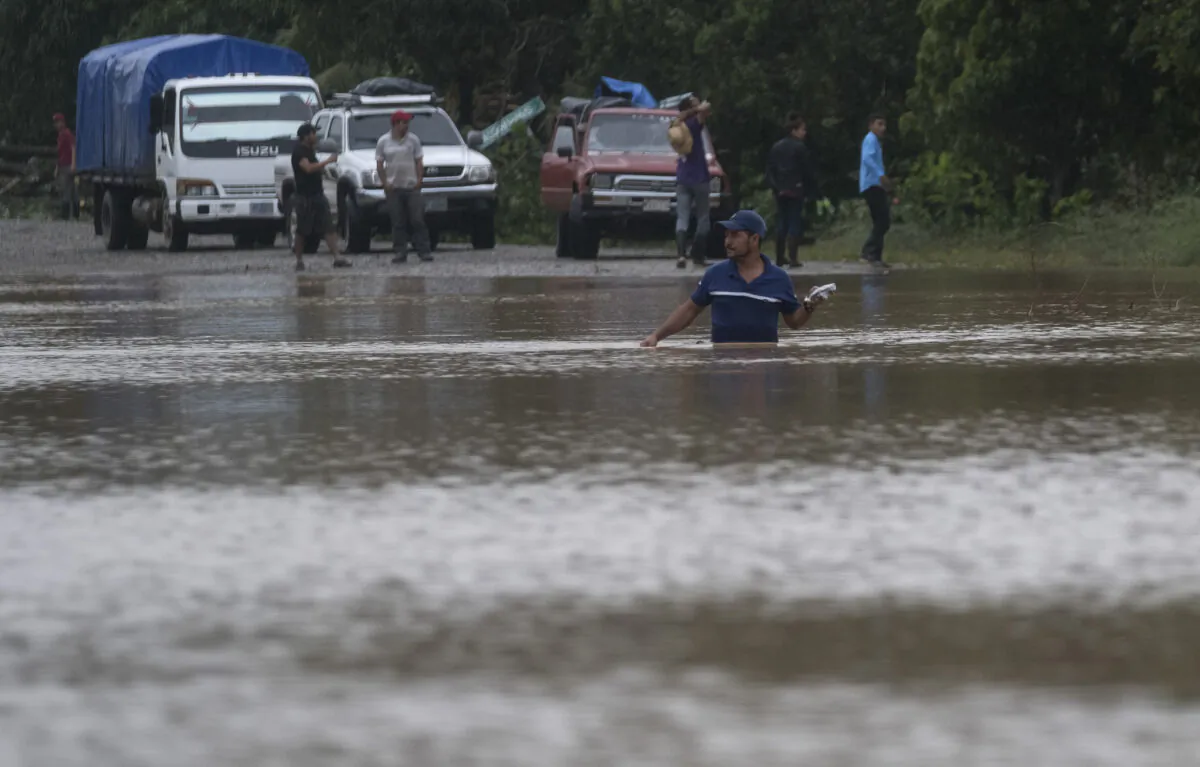 A man walks through a flooded road in Okonwas, Nicaragua, on Nov. 4, 2020. (Carlos Herrera/AP Photo) 