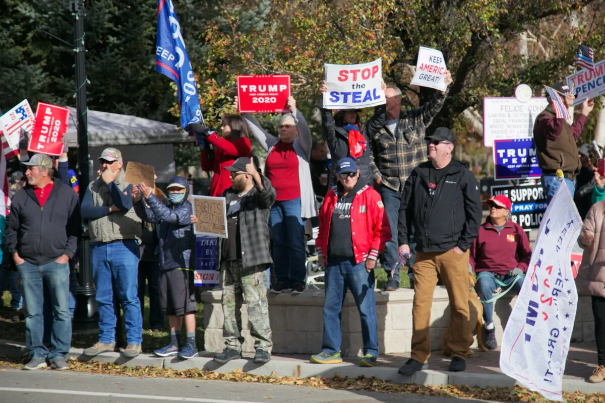 People hold signs at the “Stop the Steal” rally near the Nevada State Capitol in Carson City, Nev., on Nov. 14, 2020. (Mark Cao/NTD)
