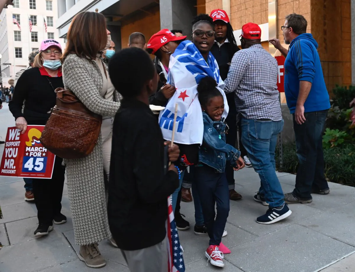 A girl cries after her family, who attended a pro-President Donald Trump march, was harassed by anti-Trump demonstrators in Washington on Nov. 14, 2020. (Andrew Caballero-Reynolds/AFP via Getty Images)