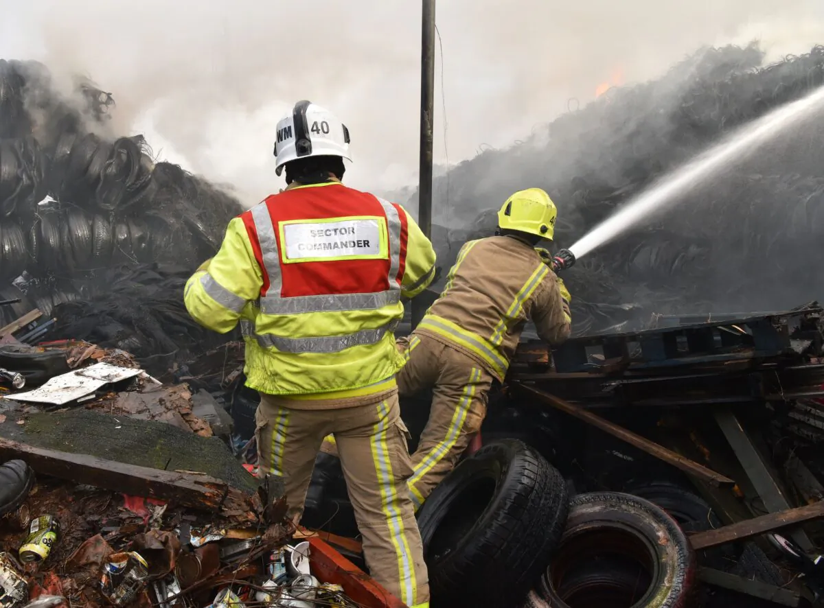 Fire fighters are seen tackling a blaze involving a large quantity of tyres at a location near the railway's Bradford Interchange in Bradford, Northern England, on Nov. 16, 2020. (West Yorkshire Fire & Rescue Service)