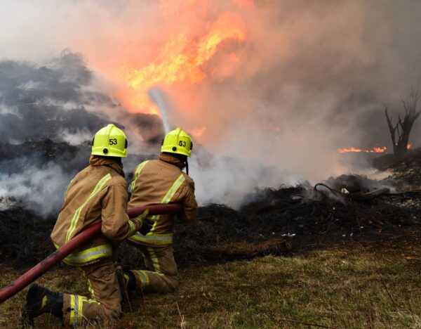 Fire fighters are seen tackling a blaze involving a large quantity of tyres at a location near the railway's Bradford
