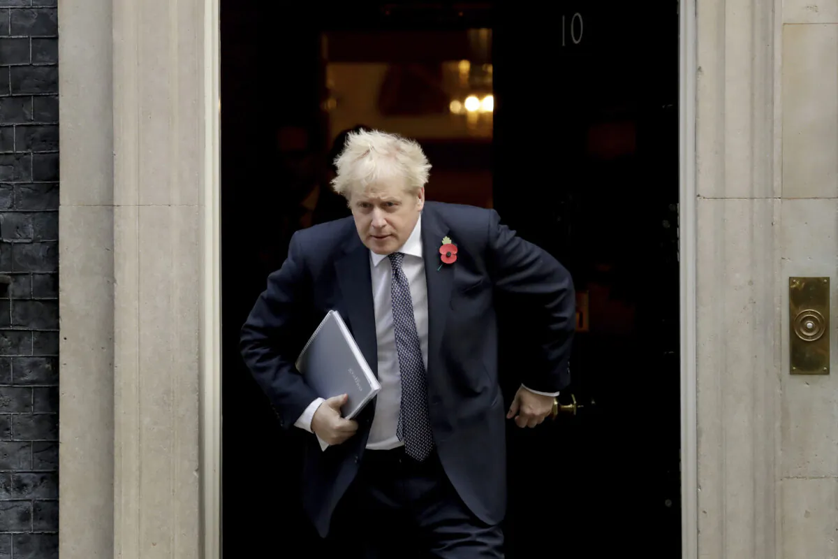 British Prime Minister Boris leaving 10 Downing Street in London on Nov. 10, 2020. Johnson is self-isolating after being told he came into contact with someone who tested positive for the CCP virus. (AP Photo/Matt Dunham)