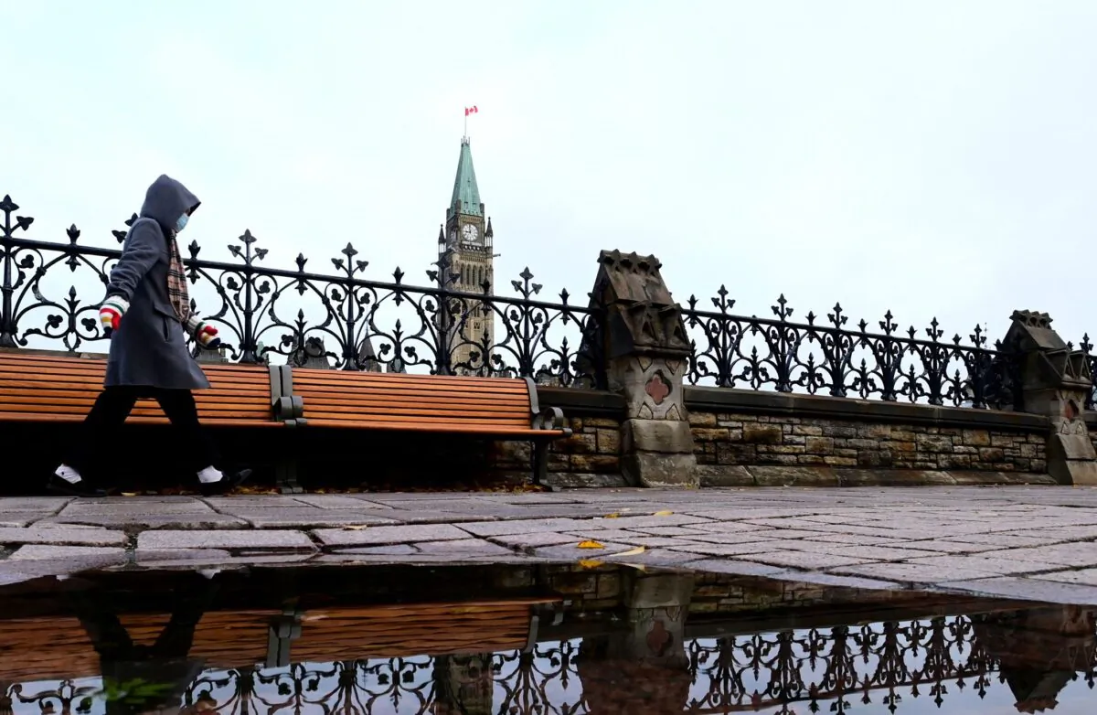 The Peace Tower is seen above the fence that borders Parliament Hill in Ottawa on Oct. 20, 2020. (The Canadian Press/Sean Kilpatrick)