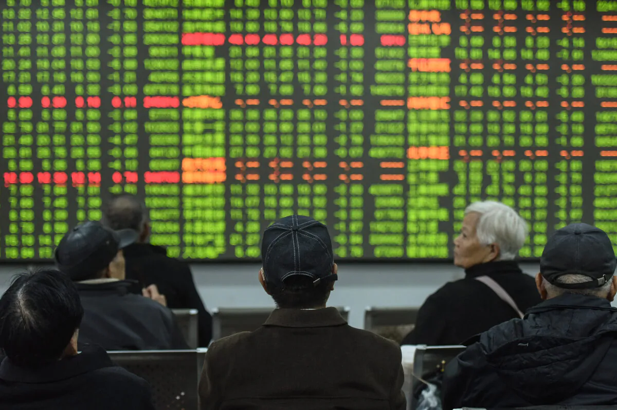 Investors look at a screen showing stock market movements at a securities company in Hangzhou in China's eastern Zhejiang province on Feb. 3, 2020. (STR/AFP via Getty Images)