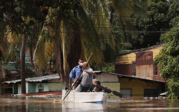 Residents paddle a boat 