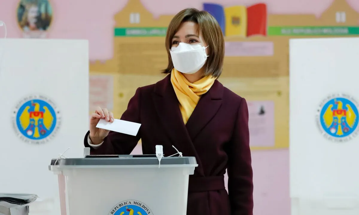 Former Prime Minister Maia Sandu prepares to cast her vote in the country's presidential election runoff in Chisinau, Moldova, on Nov. 15, 2020. (Roveliu Buga/AP Photo)