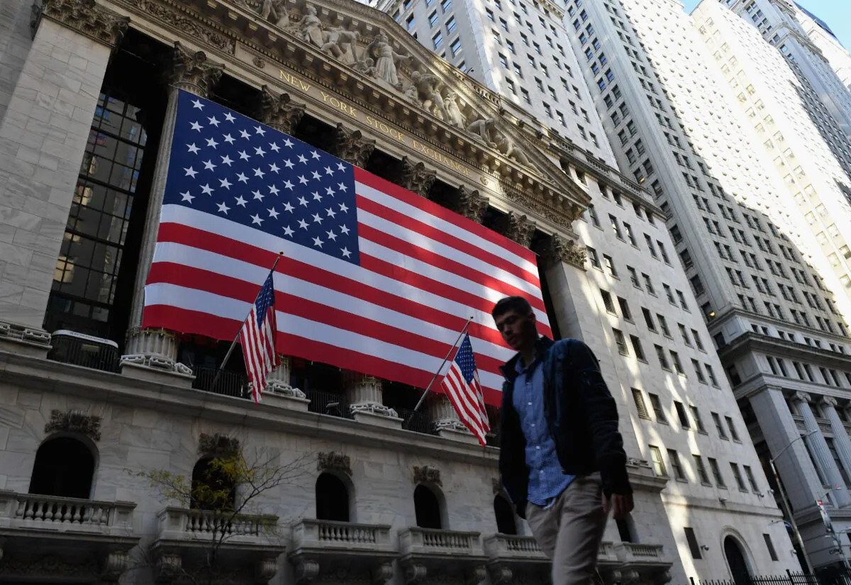 A person walks past the New York Stock Exchange at Wall Street in New York City, on Nov. 16, 2020. (ANGELA WEISS/AFP via Getty Images)