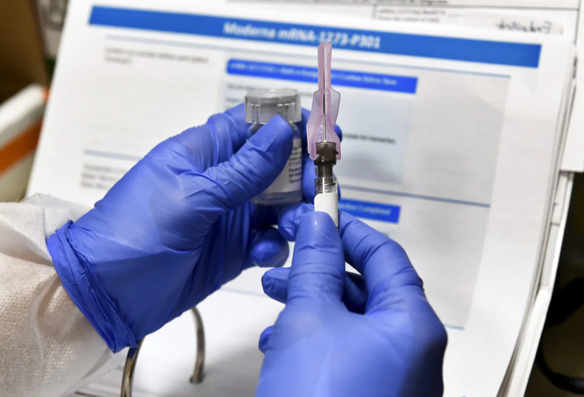A nurse prepares a blinded study experimental vaccine for the CCP virus, developed by the National Institutes of Health and Moderna, in Binghamton, N.Y., on July 27, 2020. (Hans Pennink/AP Photo)