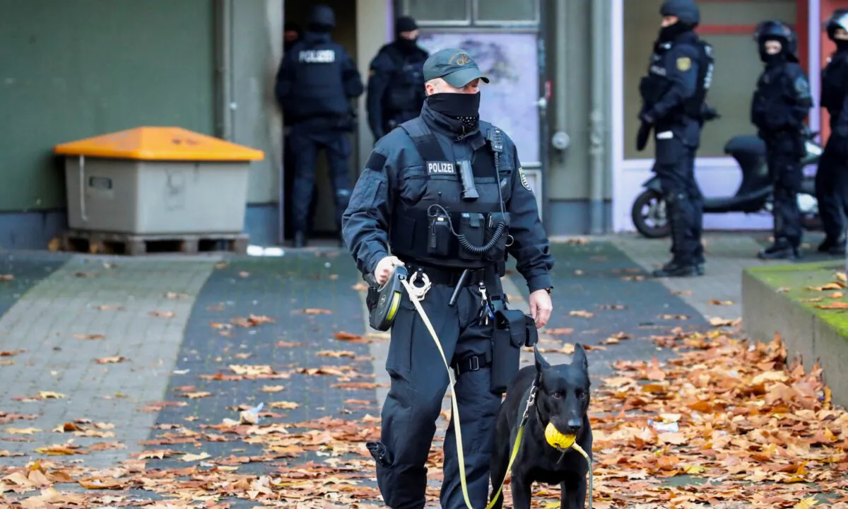 German police officers secure the area during raids in Berlin, after thieves grabbed priceless jewels from the historic Green Vault museum (Gruenes Gewoelbe) in the city of Dresden last year, in Germany, on Nov. 17, 2020. (Hannibal Hanschke/Reuters)