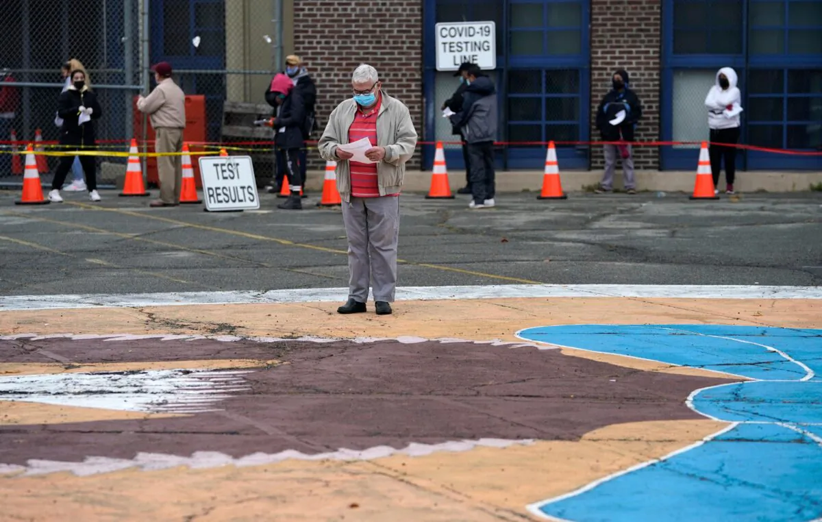 People wait in line to get tested for COVID-19 at the Ann Street School Covid-19 Testing Center in Newark, N.J., on Nov. 12, 2020. (Timothy A. Clary/AFP via Getty Images)