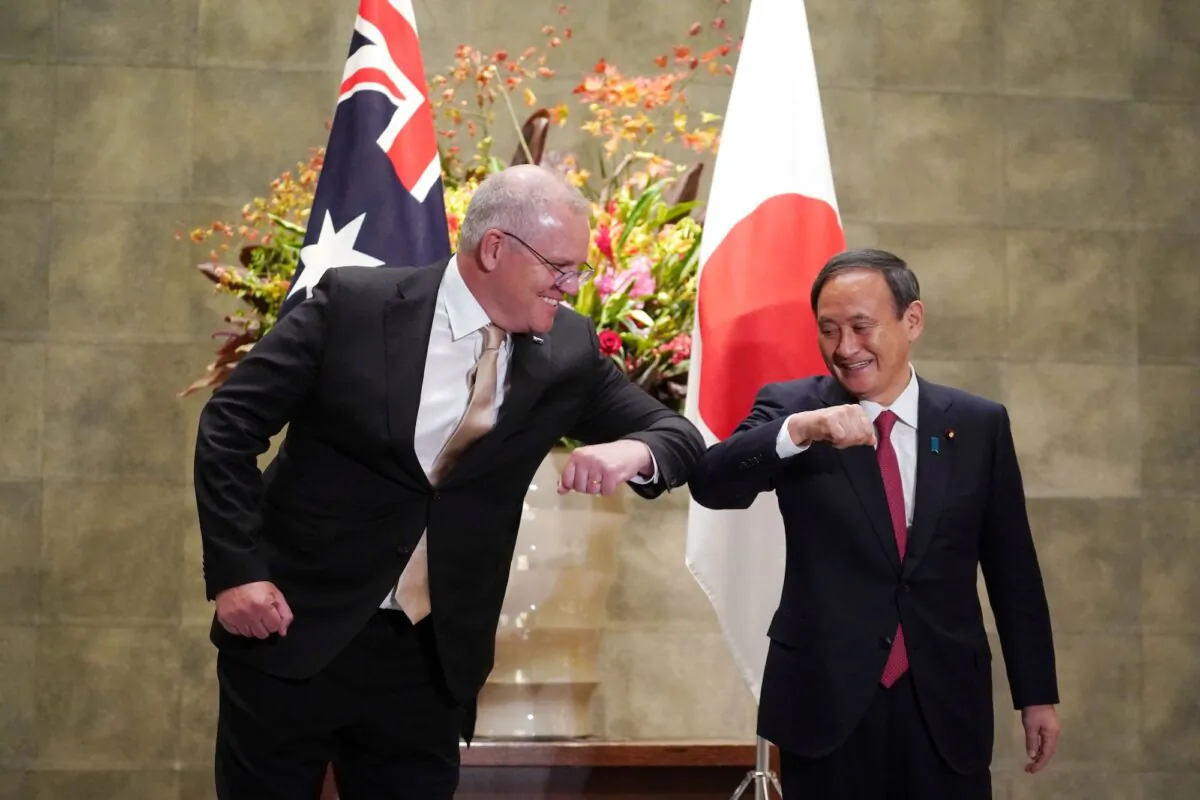 Australia's Prime Minister Scott Morrison (L) is greeted by Japan's Prime Minister Yoshihide Suga (R) prior to an official welcoming ceremony at Suga's official residence in Tokyo on November 17, 2020. (Eugene Hoshiko / POOL / AFP)