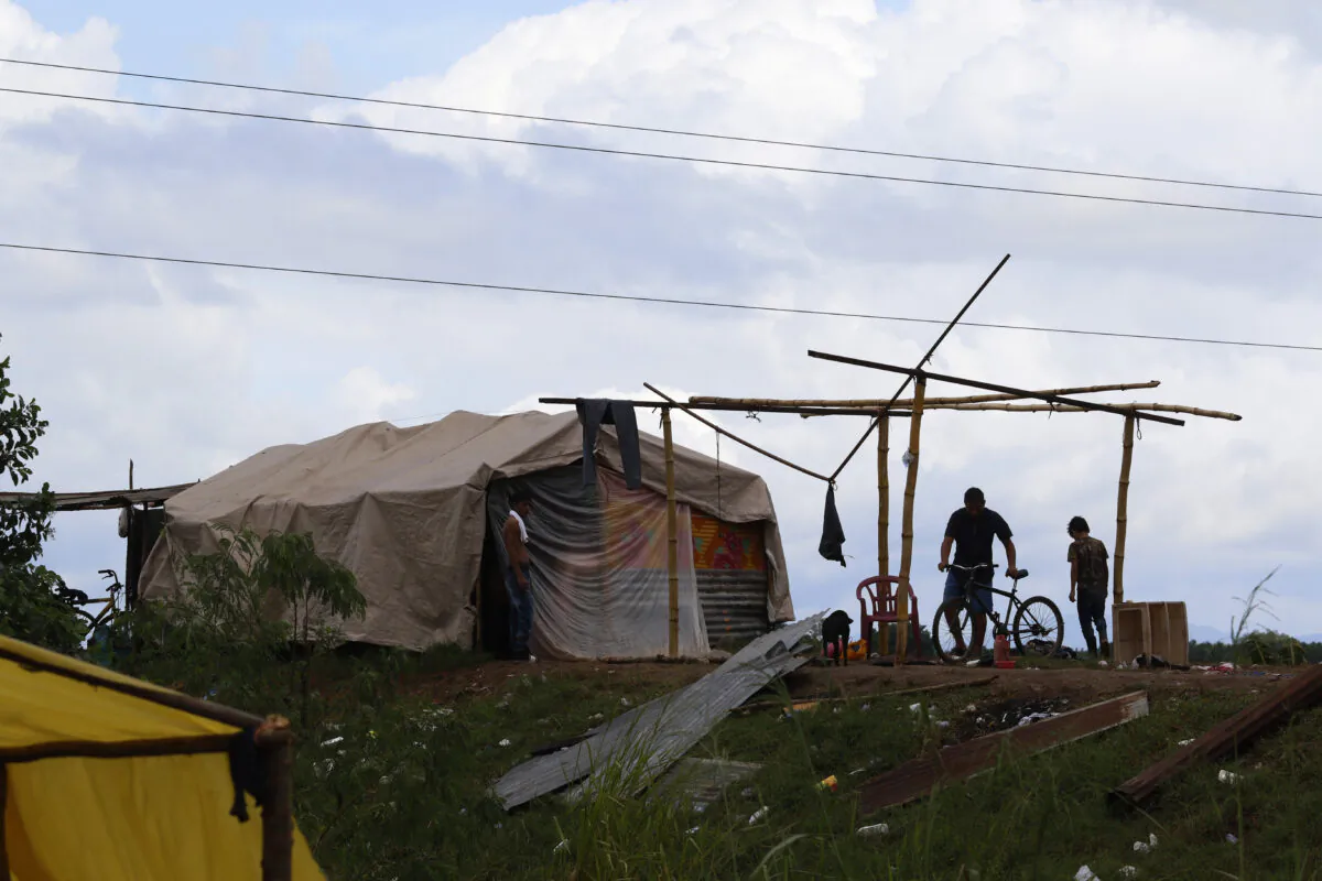 People living under precarious conditions make preparations before Hurricane Iota makes landfall in San Manuel Cortes, Honduras on Nov. 16, 2020. (Delmer Martinez/AP Photo)