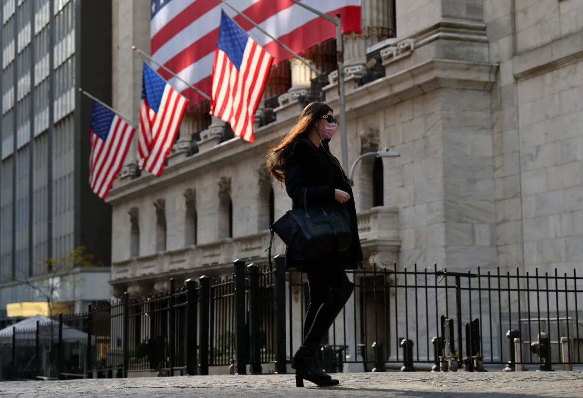 A person walks past the New York Stock Exchange on Wall Street in New York on Nov. 16, 2020. (ANGELA WEISS/AFP via Getty Images)