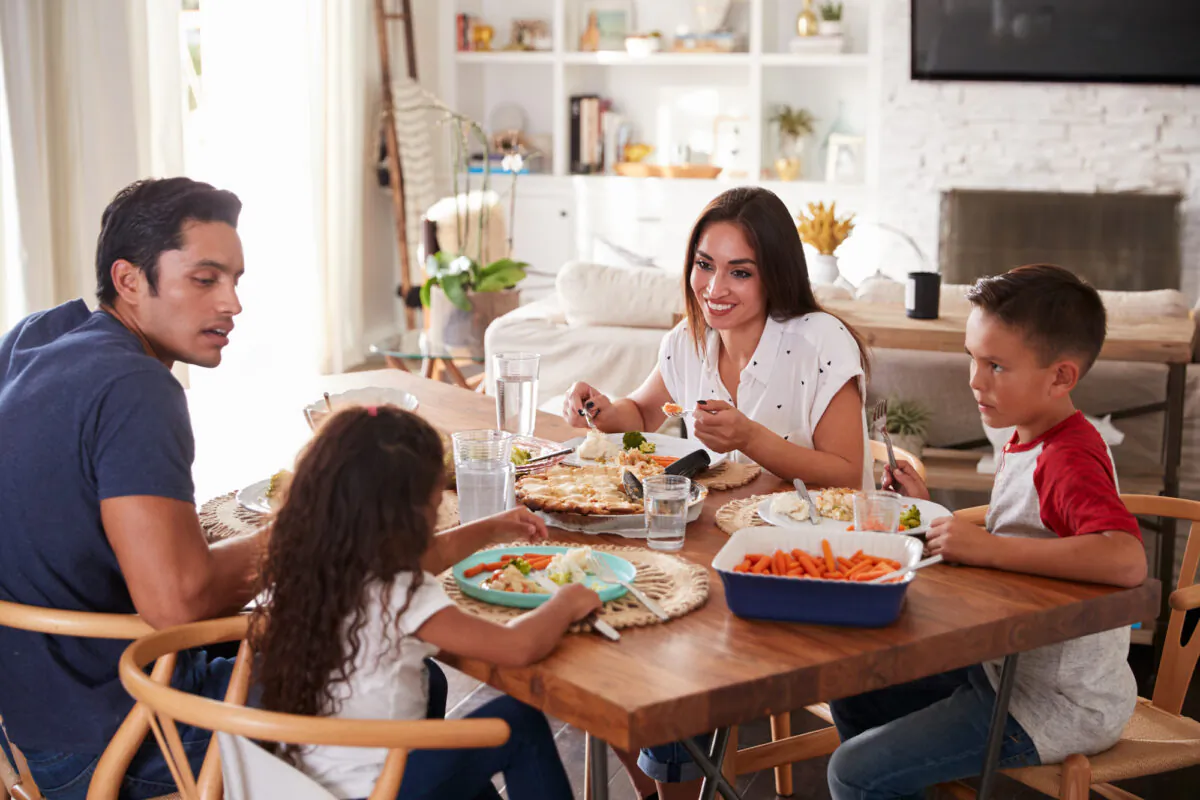 W. Cleon Skousen, author of the 1958 book “The Naked Communist.” urges parents to “make current events part of the dinner table talk." (Monkey Business Images)