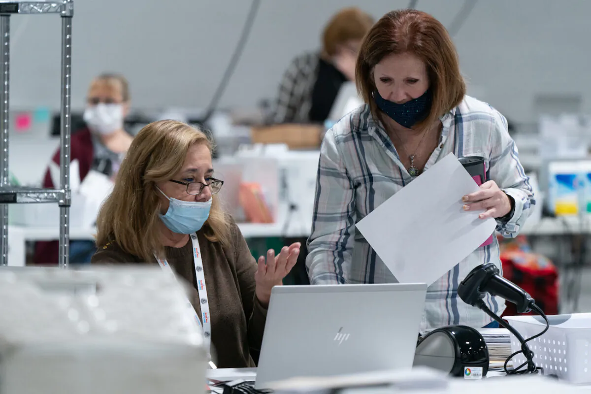 Election personnel sort ballots in preparation for an audit at the Gwinnett County Board of Voter Registrations and Elections offices in Lawrenceville, Ga., on Nov. 7, 2020. (Elijah Nouvelage/Getty Images)