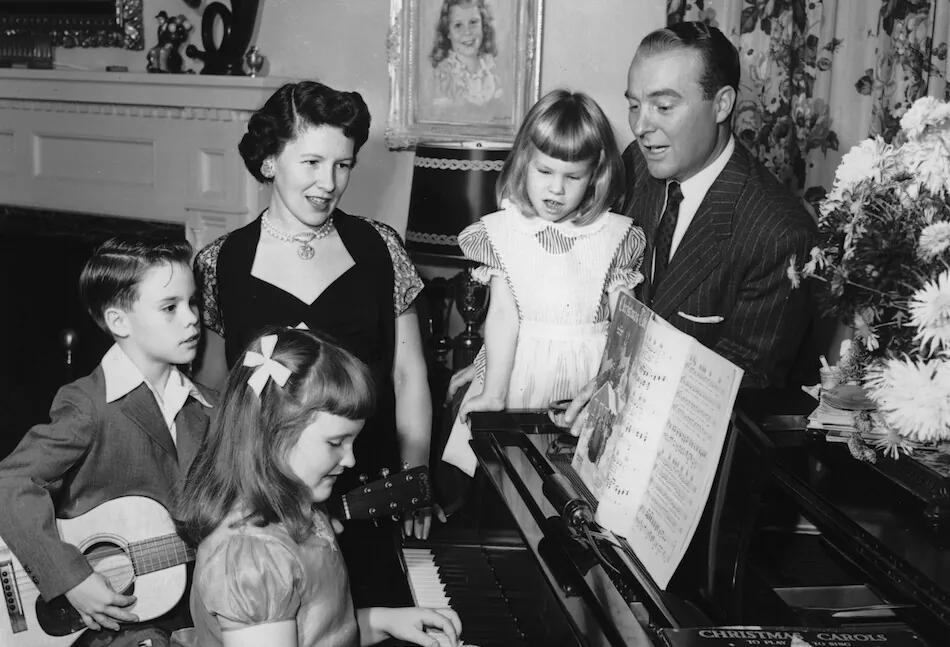 American television show host Ralph Edwards and his family sing songs around a piano, circa 1955. (Hulton Archive/Getty Images)