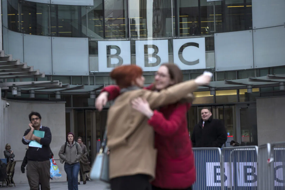 Two women embrace outside Broadcasting House, after MPs voted on a bill relating to the BBC licence fee, in London on March 25, 2014. (Oli Scarff/Getty Images)