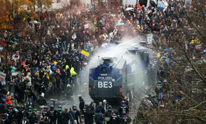 A general view of a protest against the government's coronavirus disease (COVID-19) restrictions, while police use water cannons, near the Reichstag, the seat of Germany's lower house of parliament Bundestag, in Berlin, on Nov. 18, 2020. (Fabrizio Bensch/Reuters)