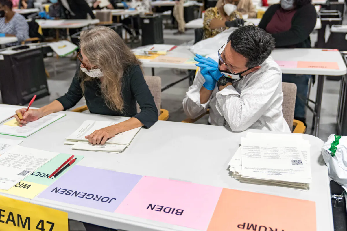 Gwinnett County election workers handle ballots as part of the recount for the 2020 presidential election at the Beauty P. Baldwin Voter Registrations and Elections Building in Lawrenceville, Georgia, on Nov. 16, 2020. (Megan Varner/Getty Images)