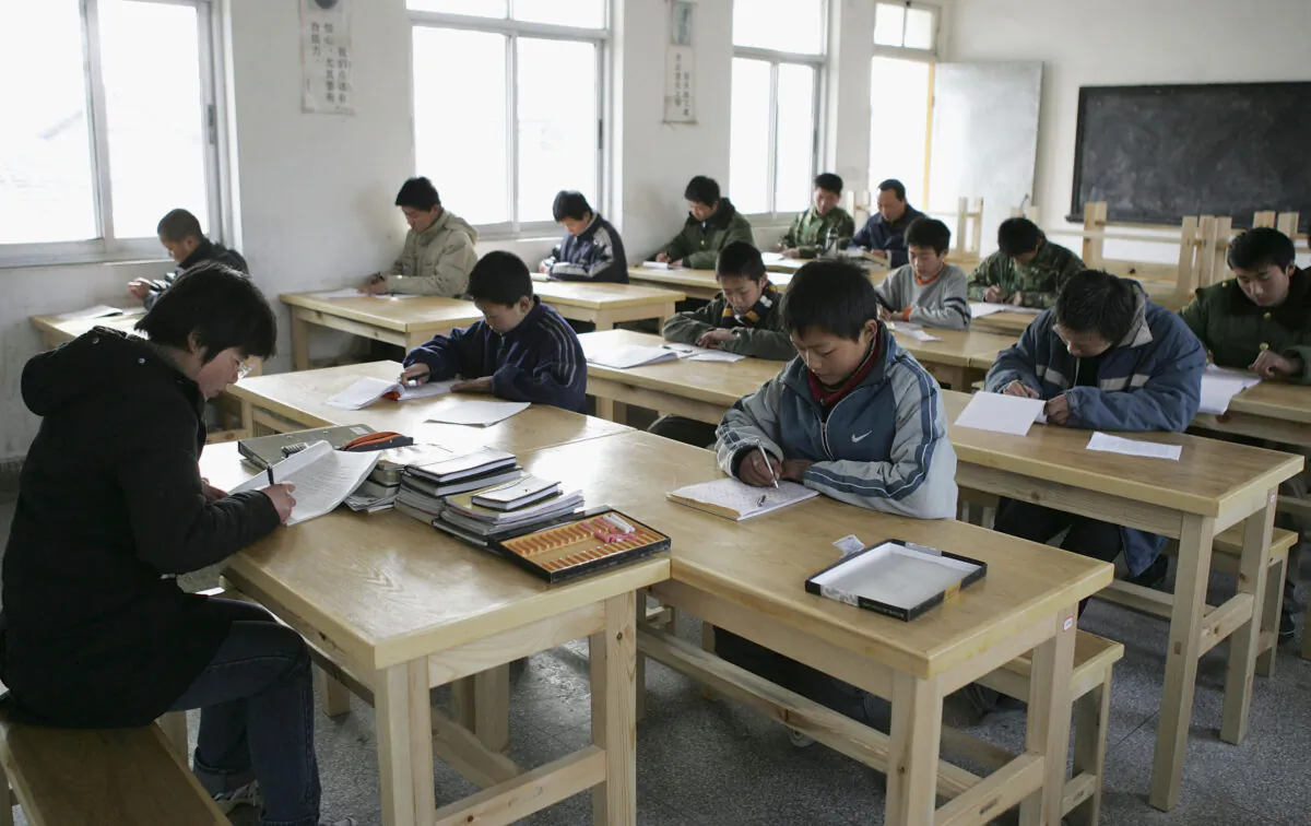 Students of the Xu Xiangyang Education and Training Workroom attend a writing class in Huaian city, Jiangsu Province, China, on March 12, 2005. (China Photos/Getty Images)