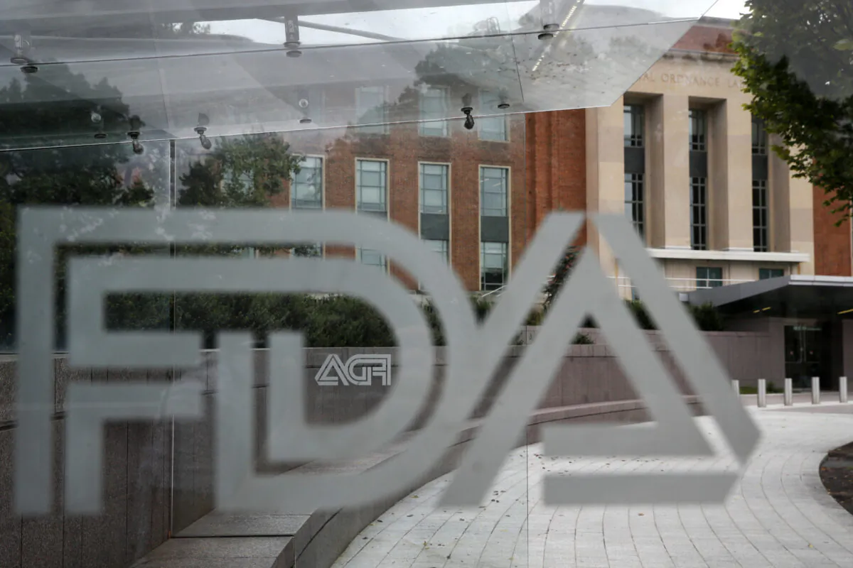 The U.S. Food and Drug Administration building behind FDA logos at a bus stop on the agency's campus in Silver Spring, Md., on Nov. 17, 2020, (Jacquelyn Martin/AP Photo)