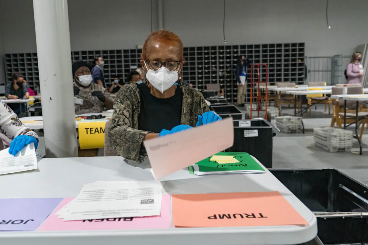 Gwinnett County election workers handle ballots as part of the recount for the 2020 presidential election at the Beauty P. Baldwin Voter Registrations and Elections Building in Lawrenceville, Georgia, on Nov. 16, 2020. (Megan Varner/Getty Images)