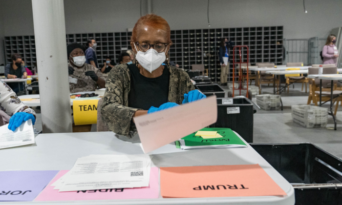 Gwinnett County election workers handle ballots as part of the recount for the 2020 presidential election at the Beauty P. Baldwin Voter Registrations and Elections Building in Lawrenceville, Georgia, on Nov. 16, 2020. (Megan Varner/Getty Images)