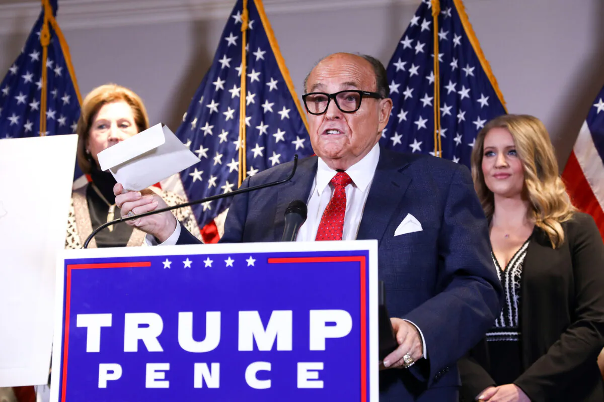 Trump lawyer and former New York City Mayor Rudy Giuliani speaks to media while flanked by lawyer Sidney Powell (L) and Trump campaign senior legal adviser Jenna Ellis at a press conference at the Republican National Committee headquarters in Washington, on Nov 19, 2020. (Charlotte Cuthbertson/The Epoch Times)