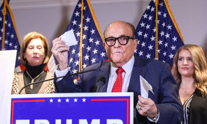 Trump lawyer and former New York City Mayor Rudy Giuliani speaks to media while flanked by Trump campaign lawyer Sidney Powell (L) and Trump campaign senior legal adviser Jenna Ellis at a press conference at the Republican National Committee headquarters in Washington on Nov. 19, 2020. (Charlotte Cuthbertson/The Epoch Times)