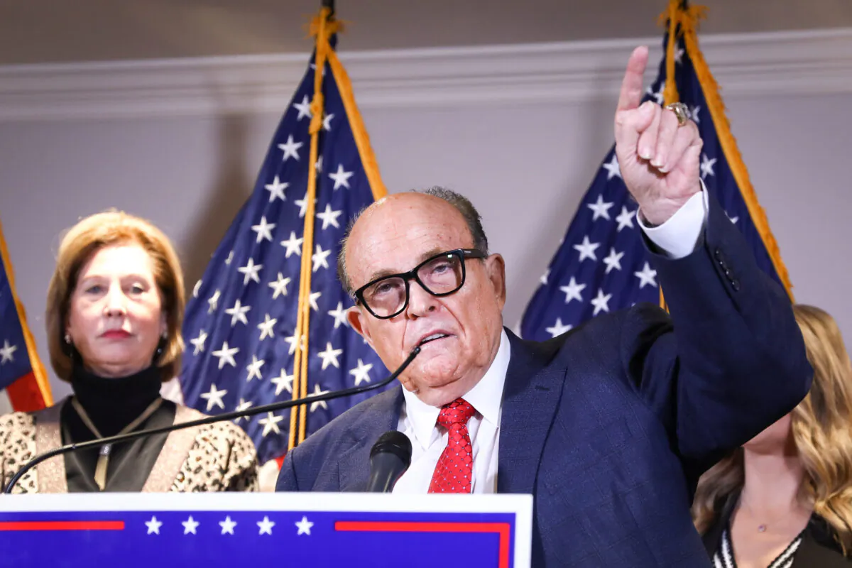 Trump lawyer and former New York City Mayor Rudy Giuliani speaks to media while flanked by Trump campaign lawyer Sidney Powell (L) and members of the Trump campaign legal team at a press conference at the Republican National Committee headquarters in Washington on Nov. 19, 2020. (Charlotte Cuthbertson/The Epoch Times)