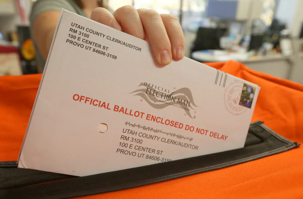 An employee at the Election office puts mail in ballots into a container to register the vote in the midterm elections in Provo, Utah, on Nov. 6, 2018. (George Frey/Getty Images)