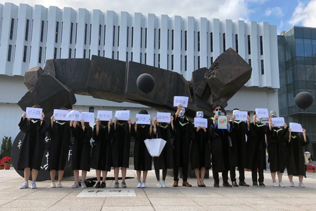Students of Chinese University of Hong Kong (CUHK) hold up the names of the 12 detained in mainland China, in Hong Kong on Nov. 19, 2020. (Sharon Tam/Reuters)