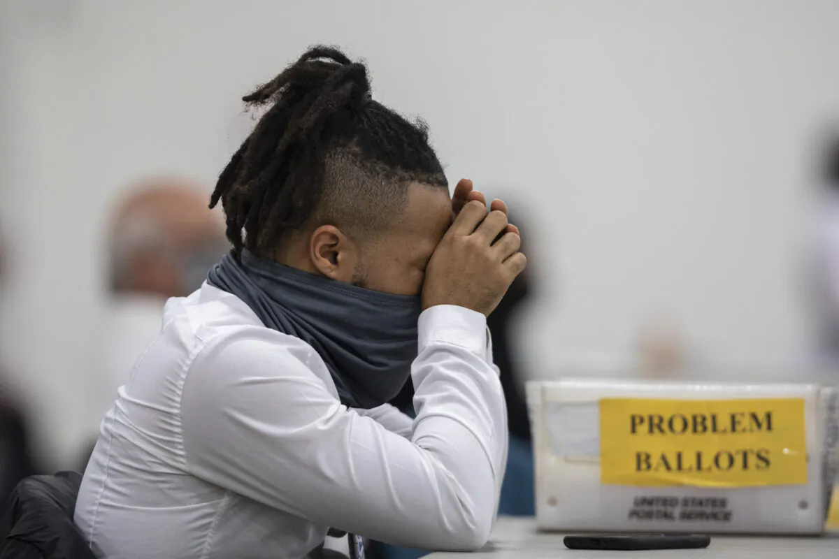 A worker with the Detroit Department of Elections takes a break after sorting through absentee ballots at the Central Counting Board in the TCF Center in Detroit, Michigan, on Nov. 4, 2020. (Elaine Cromie/Getty Images)