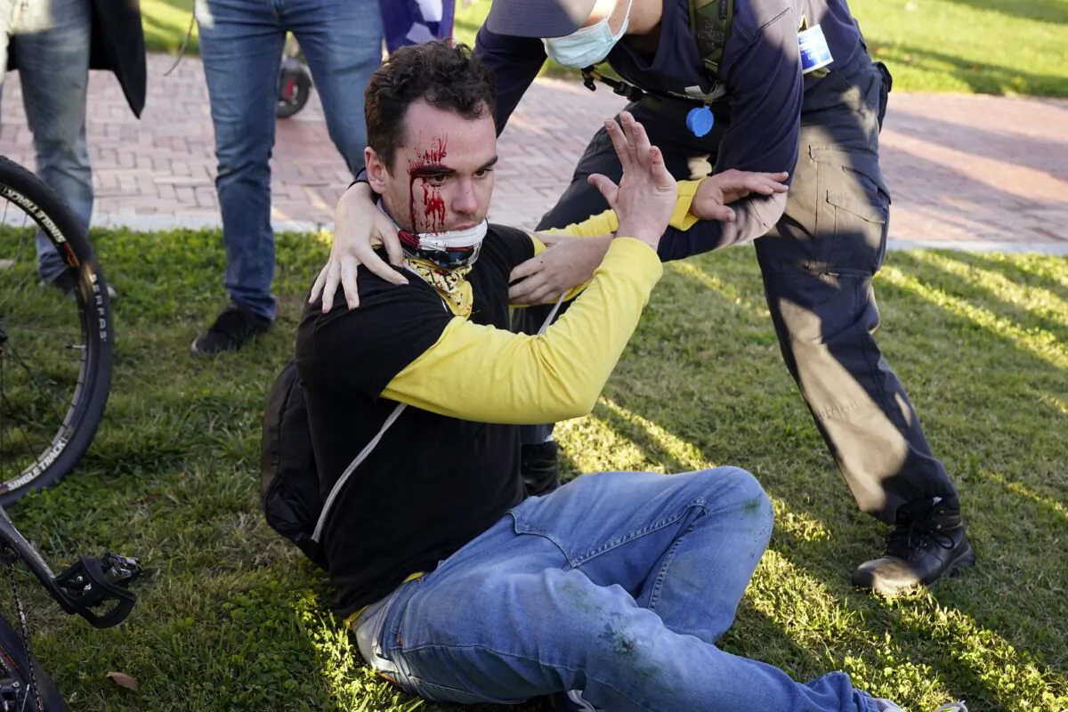 A supporter of President Donald Trump is bleeding after being assaulted by two reported Antifa members, during a pro-Trump rally in Washington on Nov. 14, 2020. (Jacquelyn Martin/AP Photo)
