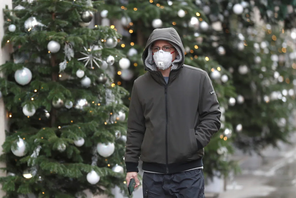 A man walks past Christmas decorations outside a store amid the CCP virus outbreak in London on Nov. 19, 2020. (Reuters/Peter Nicholls)