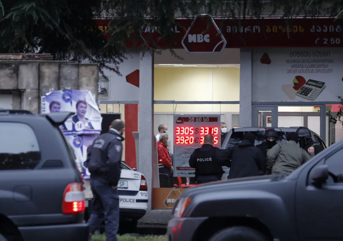 Law enforcement officers gather in a street near an office of a microfinance organization after an unidentified gunman took hostages, in Tbilisi, Georgia on Nov. 20, 2020. (Stringer Reuters)