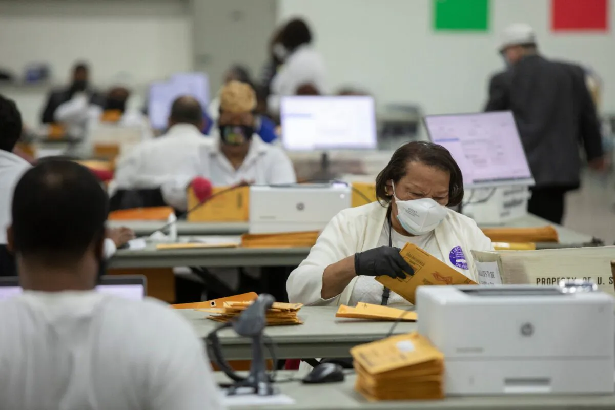 Workers with the Detroit Department of Elections sort through absentee ballots at the Central Counting Board in the TCF Center in Detroit, Mich., on Nov. 2, 2020. (Elaine Cromie/Getty Images)