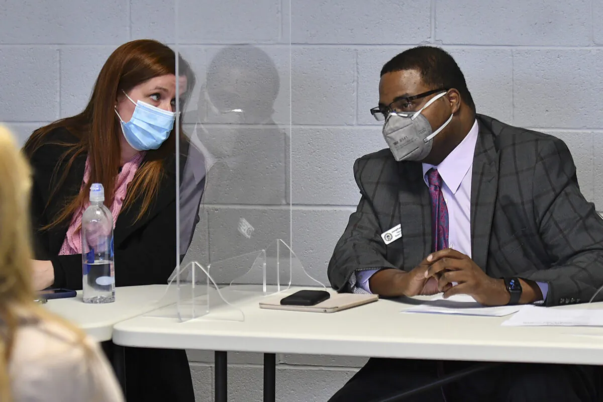 Wayne County Board of Canvassers Chair Monica Palmer, left, speaks to Vice Chair Jonathan Kinloch before the board's meeting in Detroit, Mich., on Nov. 17, 2020. (Robin Buckson/Detroit News via AP